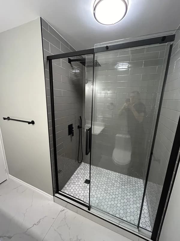Modern bathroom renovation in London Ontario with large shower, new fixtures and large format tile