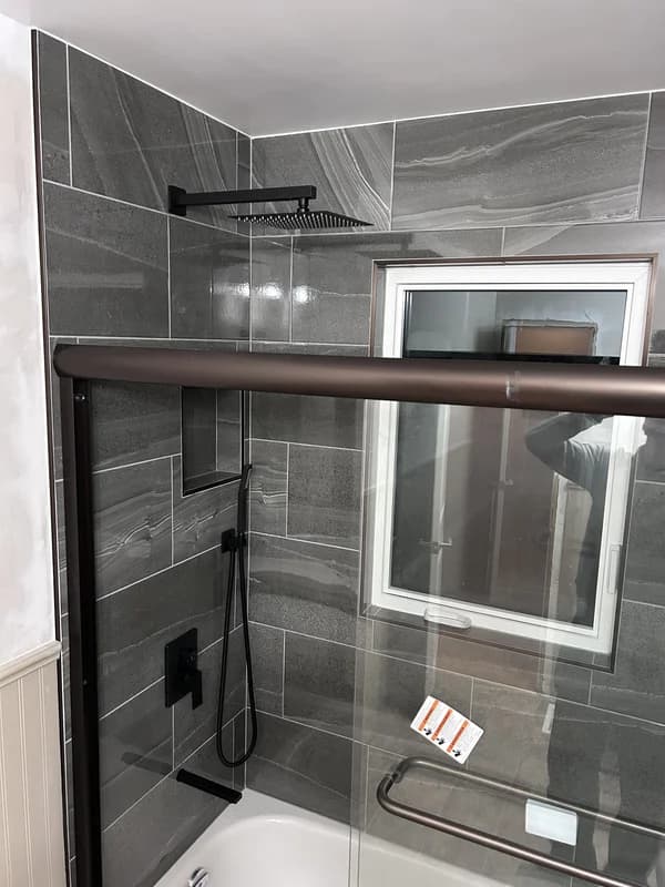 Bathtub surround with Italian tile and glass sliding doors in Strathroy Ontario